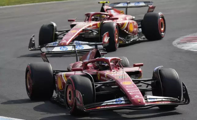 Ferrari driver Charles Leclerc of Monaco steers his car in front of Ferrari driver Carlos Sainz of Spain during qualifying session ahead of the Formula One Italian Grand Prix race at the Monza racetrack, in Monza, Italy, Saturday, Aug. 31, 2024. (AP Photo/Luca Bruno)