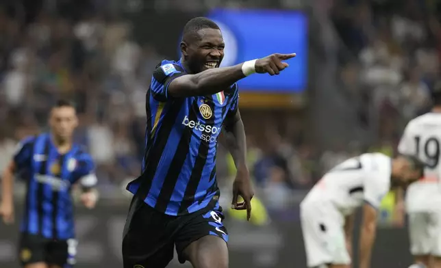 Inter Milan's Marcus Thuram celebrates scoring his side's 3rd goal during the Serie A soccer match between Inter Milan and Atalanta at the at the San Siro stadium in Milan, Italy, Friday, Aug. 30, 2024. (AP Photo/Luca Bruno)