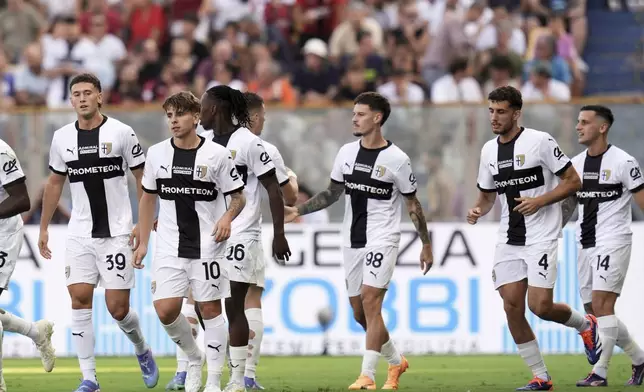 Parma's Dennis Man, center, celebrates scoring with teammates during the Serie A soccer match between Parma and Milan at Ennio Tardini Stadium, Parma, Italy, Saturday Aug. 24, 2024. (Massimo Paolone/LaPresse via AP)