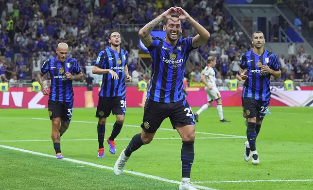 Inter's Hakan Calhanoglu celebrates after his side's second goal during the Serie A soccer match between Inter and Lecce at the San Siro Stadium in Milan, Italy, Saturday, Aug. 24, 2024. (Spada/LaPresse via AP)