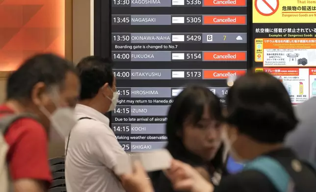 A departing flight information board shows that some flights were canceled due to an approaching Typhoon Shanshan at Haneda airport Thursday, Aug. 29, 2024, in Tokyo. (AP Photo/Eugene Hoshiko)