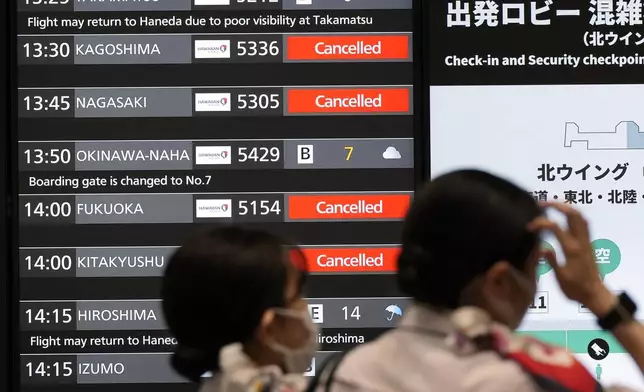 A departing flight information board shows that some flights were canceled due to an approaching Typhoon Shanshan at Haneda airport Thursday, Aug. 29, 2024, in Tokyo. (AP Photo/Eugene Hoshiko)