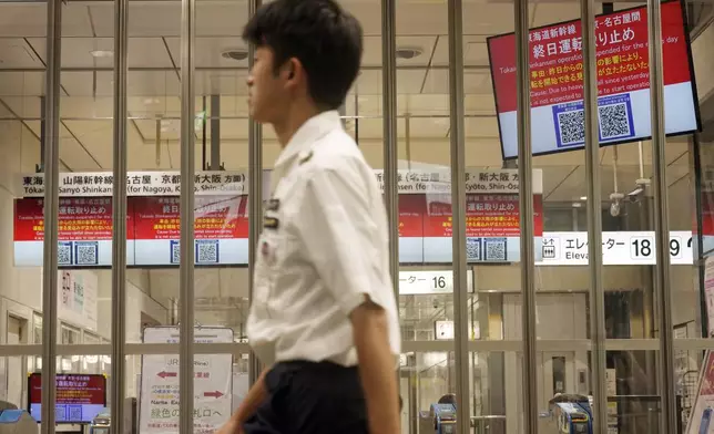 The gate for Tokaido and Sanyo Shinkansen trains is closed as all trains toward to Nagoya or westward are canceled due to heavy rainfall caused by Typhoon Shanshan at Tokyo Station, Friday, Aug. 30, 2024, in Tokyo. (AP Photo/Eugene Hoshiko)