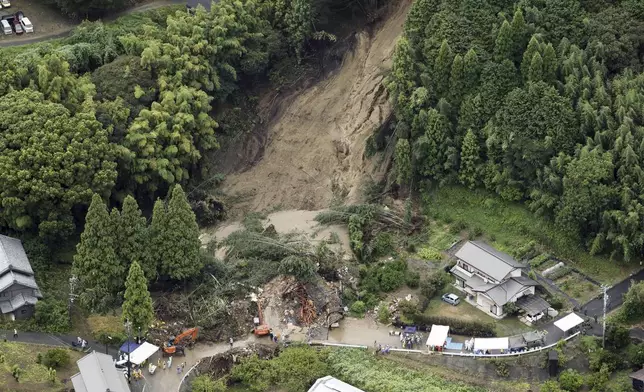 This aerial image shows the landslide in Gamagori, Aichi prefecture, Japan, Wednesday, Aug. 28, 2024. Ahead of the typhoon's arrival, heavy rain caused a landslide that buried a house in the central city of Gamagori. (Kyodo News via AP)