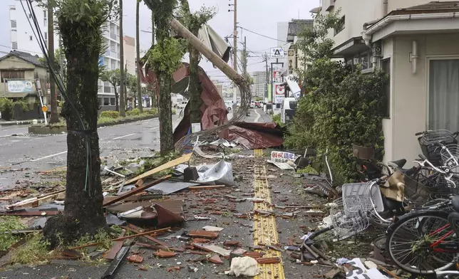 Roof tiles are seen scattered by strong winds of a typhoon at a residential area in Miyazaki, western Japan, Thursday, Aug. 29, 2024. (Kyodo News via AP)