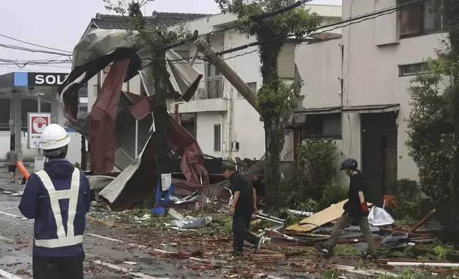 Roof tiles are seen scattered blown away by strong winds of a typhoon in Miyazaki, western Japan, Thursday, Aug. 29, 2024. (Kyodo News via AP)