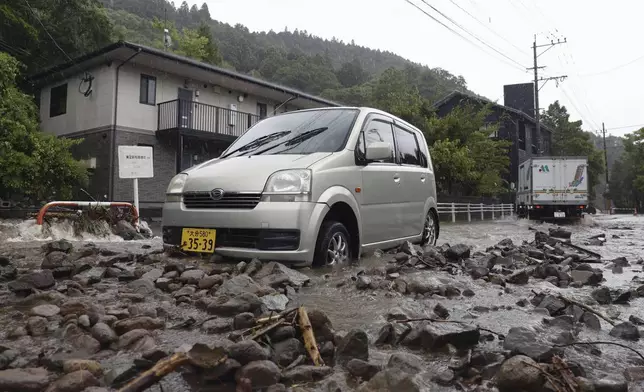 A road is covered by mud and stones as a typhoon hits the city in Yufu, Oita prefecture western Japan, Thursday, Aug. 29, 2024. (Kyodo News via AP)