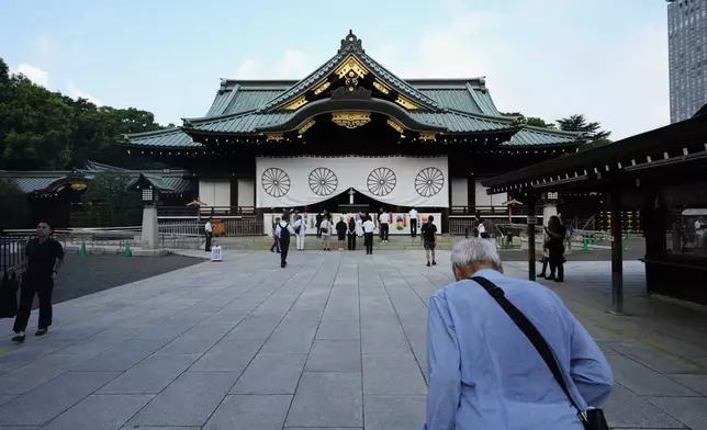 A man bows in front of the main hall of the Yasukuni Shrine, which honors Japan's war dead, in Tokyo, Japan, Thursday, Aug. 15, 2024, as the country marks the 79th anniversary of its defeat in the World War II. (AP Photo/Hiro Komae)