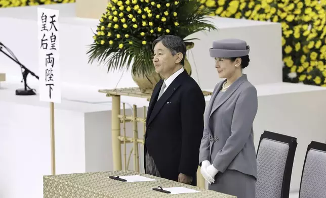 Japan's Emperor Naruhito, left, and Empress Masako, left, attend a memorial service for the war dead at the Nippon Budokan hall in Tokyo, as the country marks the 79th anniversary of its defeat in the World War II, Thursday, Aug. 15, 2024. (Kyodo News via AP)