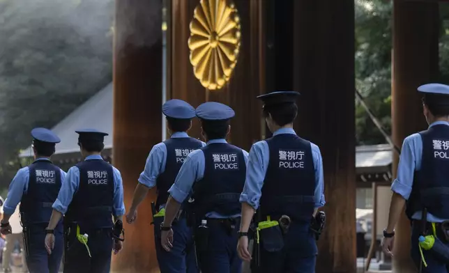 Police officers walk around the Yasukuni Shrine, which honors Japan's war dead, in Tokyo, Japan, Thursday, Aug. 15, 2024, as the country marks the 79th anniversary of its defeat in the World War II. (AP Photo/Hiro Komae)