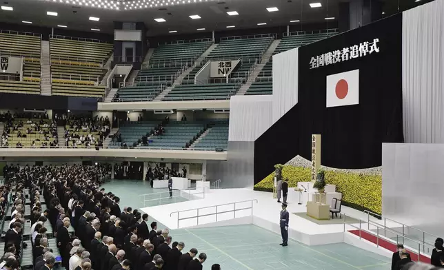 Japan's Emperor Naruhito, center right, and Empress Masako, center left, observe a moment of silence during a memorial service for the war dead at the Nippon Budokan hall in Tokyo, as the country marks the 79th anniversary of its defeat in the World War II, Thursday, Aug. 15, 2024. (Kyodo News via AP)