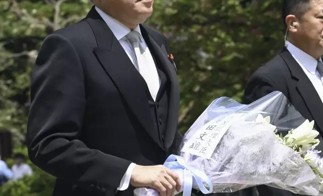 Japan’s Prime Minister Fumio Kishida visit to offer flowers at the Chidorigafuchi National Cemetery as the country marks the 79th anniversary of its defeat in the World War II, in Tokyo, Thursday, Aug. 15, 2024. (Kyodo News via AP)