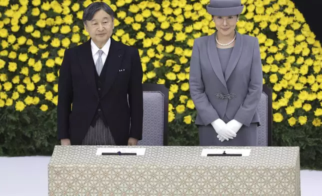 Japanese Emperor Naruhito, left, and Empress Masako, right, attend the memorial ceremony for the war dead at the Nippon Budokan hall in Tokyo, as the country marks the 79th anniversary of its defeat in the World War II, Thursday, Aug. 15, 2024. (Kyodo News via AP)