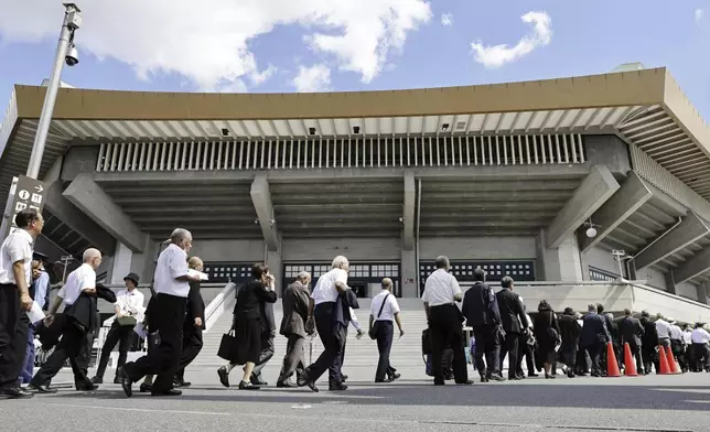 People arrive for the memorial ceremony marking the 79th anniversary of Japan's defeat in the World War II, at the Nippon Budokan hall in Tokyo, Thursday, Aug. 15, 2024. (Kyodo News via AP)