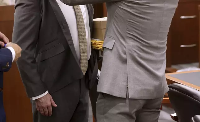 Defense attorney Robert Draskovich, right, adjusts the collar of his client Robert Telles prior to jury selection on the second day of Telles' murder trial at the Regional Justice Center in Las Vegas Tuesday, Aug. 13, 2024. Telles, a former Clark County public administrator, is charged in the murder of Las Vegas Review-Journal investigative journalist Jeff German. (K.M. Cannon/Las Vegas Review-Journal via AP, Pool)