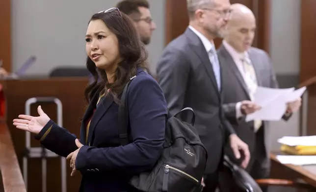 Robert Telles, right, looks at papers as his former employee Roberta Lee-Kennett walks by during a break during Telles' murder trial at the Regional Justice Center in Las Vegas, Friday, Aug. 16, 2024. (K.M. Cannon/Las Vegas Review-Journal via AP, Pool)