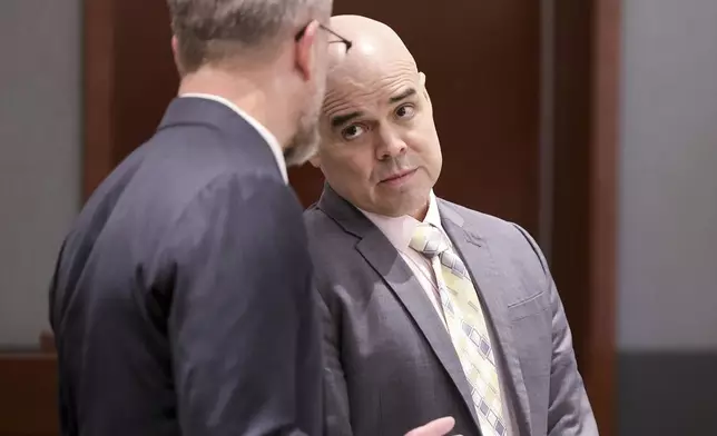 Robert Telles, a former Clark County public administrator charged in the murder of Las Vegas Review-Journal investigative journalist Jeff German, right, talks with attorney Robert Draskovich during a break in testimony during his murder trial at the Regional Justice Center in Las Vegas, Friday, Aug. 16, 2024. (K.M. Cannon/Las Vegas Review-Journal via AP, Pool)