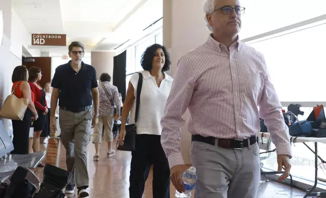 Jill Zwerg, center, a sister of investigative reporter Jeff German, and her brother Jay German, right, leave a courtroom after former Clark County Public Administrator Robert Telles was found guilty of murdering German, at the Regional Justice Center, on Wednesday, Aug. 28, 2024, in Las Vegas, on Wednesday, Aug. 28, 2024, in Las Vegas. (Bizuayehu Tesfaye/Las Vegas Review-Journal via AP)