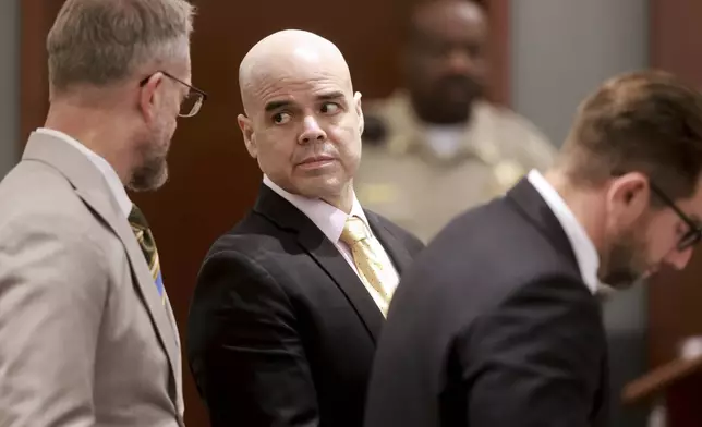 Robert Telles, center, is flanked by his attorneys Robert Draskovich, left, and Michael Horvath during his murder trial at the Regional Justice Center in Las Vegas, Friday, Aug. 23, 2024. Telles, a former Clark County public administrator, is charged in the murder of Las Vegas Review-Journal investigative journalist Jeff German. (K.M. Cannon/Las Vegas Review-Journal via AP)