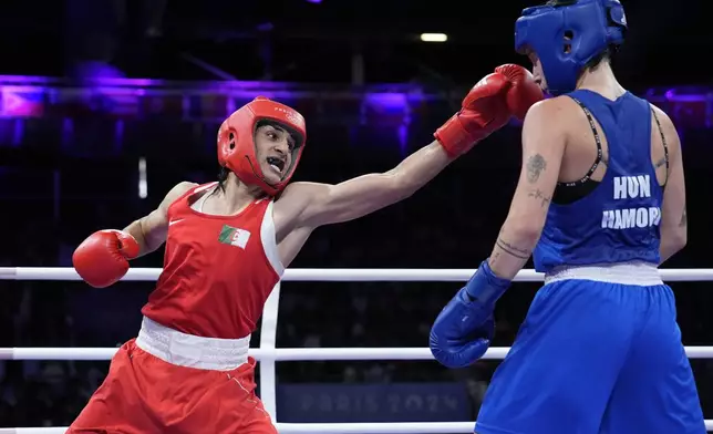 Algeria's Imane Khelif hits Hungary's Anna Hamori in their women's 66kg quarterfinal boxing match at the 2024 Summer Olympics, Saturday, Aug. 3, 2024, in Paris, France. (AP Photo/John Locher)