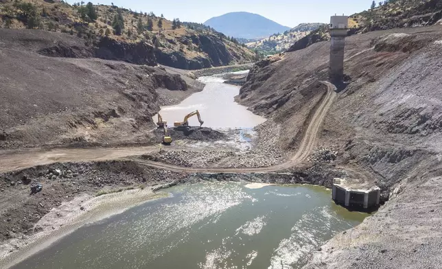 This image provided by Swiftwater Films shows a downstream view of crews working at the Iron Gate coffer dam site along the Klamath River on Tuesday, Aug. 27, 2024, in Siskiyou County, Calif. (Shane Anderson/Swiftwater Films via AP)