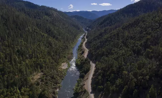 FILE - The Klamath River winds runs along Highway 96 on June 7, 2021, near Happy Camp, Calif. (AP Photo/Nathan Howard, File)