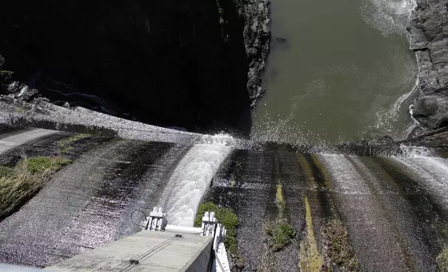 FILE - Excess water spills over the top of a dam on the Lower Klamath River known as Copco 1 near Hornbrook, Calif. (AP Photo/Gillian Flaccus, File)