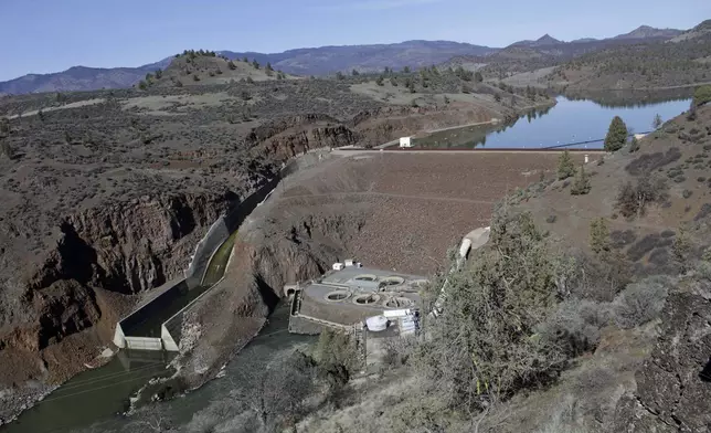 FILE - The Iron Gate Dam powerhouse and spillway are seen on the lower Klamath River near Hornbrook, Calif., on March 2, 2020. (AP Photo/Gillian Flaccus, File)