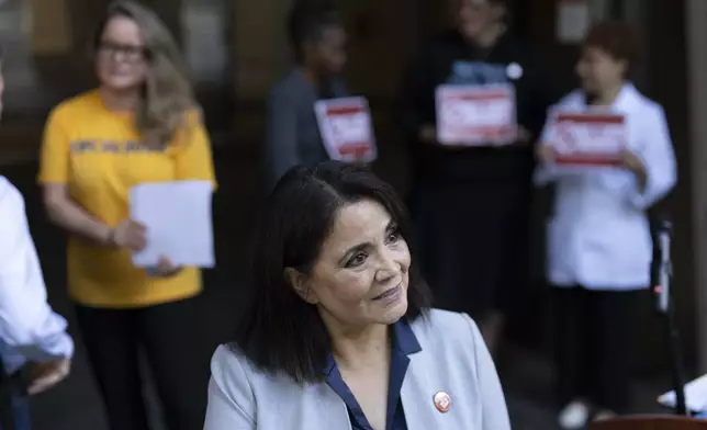 Kim Cordova, president of UFCW 7, center, speaks to reporters after a news conference about the Kroger and Albertsons merger outside the federal courthouse before a hearing on the merger on Monday, Aug. 26, 2024, in Portland, Ore.(AP Photo/Jenny Kane)