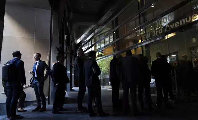 People line up outside the federal courthouse before a Kroger and Albertsons merger hearing on Monday, Aug. 26, 2024, in Portland, Ore. The two companies proposed what would be the largest supermarket merger in U.S. history in October 2022. (AP Photo/Jenny Kane)