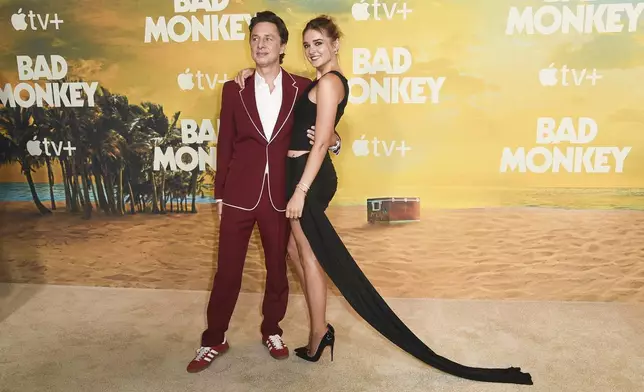 Zach Braff, left, and Charlotte Lawrence arrive at the premiere of "Bad Monkey" on Monday, Aug. 12, 2024, in Los Angeles. (Photo by Richard Shotwell/Invision/AP)