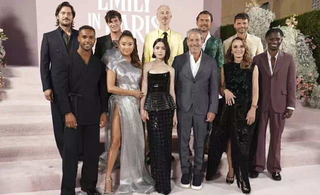 Lucas Bravo, from left, Lucien Laviscount, Paul Forman, Ashley Park, Bruno Gouery, Lily Collins, Darren Star, William Abadie, Philippine Leroy-Beaulieu, Arnaud Binard and Samuel Arnold arrive at the premiere of "Emily in Paris" at the Egyptian Theatre, Wednesday, Aug. 14, 2024, in Los Angeles. (Photo by Jordan Strauss/Invision/AP)