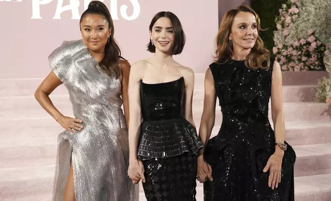 Ashley Park, from left, Lily Collins and Philippine Leroy-Beaulieu arrive at the premiere of "Emily in Paris" at the Egyptian Theatre, Wednesday, Aug. 14, 2024, in Los Angeles. (Photo by Jordan Strauss/Invision/AP)