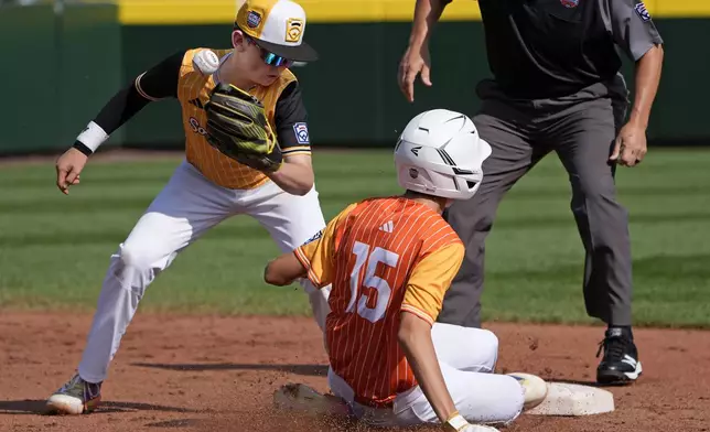 Boerne, Texas' Julian Hurst (15) steals second base on a wild pitch as the ball gets away from Lake Mary, Fla.'s Chase Anderson, left, during the first inning of the United States Championship baseball game at the Little League World Series tournament in South Williamsport, Pa., Saturday, Aug. 24, 2024. (AP Photo/Gene J. Puskar)