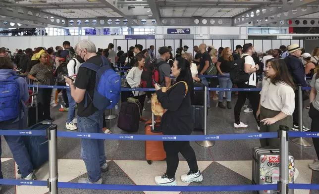 Travelers stand in a security line at O'Hare International Airport in Chicago on Friday, Aug. 30, 2024. (AP Photo/Teresa Crawford)