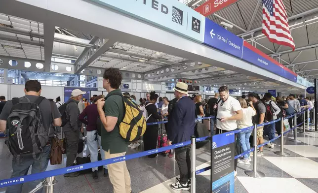 Travelers stand in a security line at O'Hare International Airport in Chicago on Friday, Aug. 30, 2024. (AP Photo/Teresa Crawford)