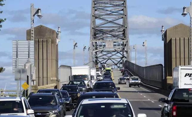 Traffic crosses the Bourne Bridge onto Cape Cod, Friday, Aug. 30, 2024, in Bourne, Mass. (AP Photo/Michael Dwyer)