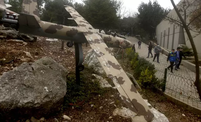 People pass by a replica drone in a war museum operated by Hezbollah in Mlita village, southern Lebanon, on Feb. 19, 2022. (AP Photo/Mohammed Zaatari, File)