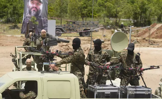 Hezbollah militants take part in a military exercise with armed drones in Aaramta village in the Jezzine District, southern Lebanon, on May 21, 2023. (AP Photo/Hassan Ammar)