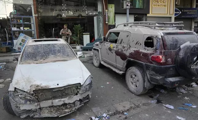 A Lebanese soldier, background, stands guards next to damaged cars at the scene where an Israeli airstrike on Tuesday evening hit a building in the southern suburbs of Beirut, Lebanon, Wednesday, July 31, 2024. Israel on Tuesday carried out a rare strike on Beirut, which it said killed a top Hezbollah commander who was allegedly behind a weekend rocket attack that killed 12 young people in the Israeli-controlled Golan Heights. (AP Photo/Hussein Malla)