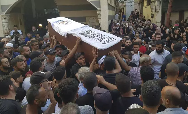 Palestinian mourners carry the coffin of Khalil al-Maqdah, the brother of Fatah Gen. Mounir al-Maqdah, who was killed by an Israeli strike on a vehicle in the southern port city of Sidon, during his funeral procession at the Palestinian refugee camp of Ein el-Hilweh, south Lebanon, Wednesday, Aug. 21, 2024. (AP Photo/Mohammed Zaatari)