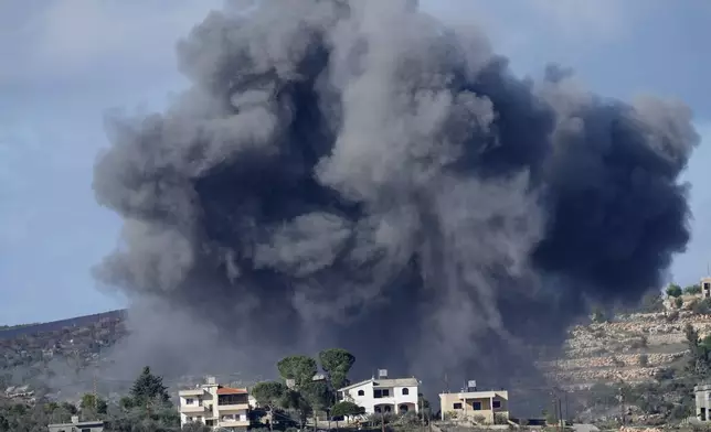 FILE - Black smoke rises from an Israeli airstrike on the outskirts of Aita al-Shaab, a Lebanese border village with Israel as it is seen from Rmeish village in south Lebanon, Nov. 21, 2023. (AP Photo/Hussein Malla, File)