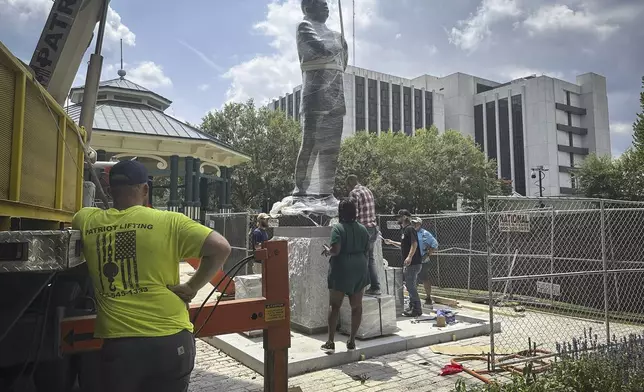 A large bronze statue of the late civil rights leader and politician Congressman John Lewis is installed where a monument to the Confederacy was brought down in 2020, in the wake of the death of George Floyd, Friday, Aug. 16, 2024, in Decatur, Ga. (AP Photo/Ron Harris)