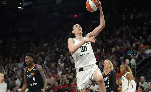 New York Liberty forward Breanna Stewart (30) drives past Phoenix Mercury forward Natasha Mack (4) to score during the first half of a WNBA basketball game Monday, Aug. 26, 2024, in Phoenix. (AP Photo/Ross D. Franklin)