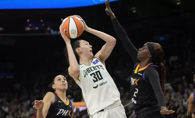 New York Liberty forward Breanna Stewart (30) looks to shoot between Phoenix Mercury guards Kahleah Copper (2) and Diana Taurasi, left, during the first half of a WNBA basketball game Monday, Aug. 26, 2024, in Phoenix. (AP Photo/Ross D. Franklin)