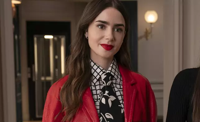 This image released by Netflix shows Lily Collins in a scene from "Emily in Paris." (Stephanie Branchu/Netflix via AP)