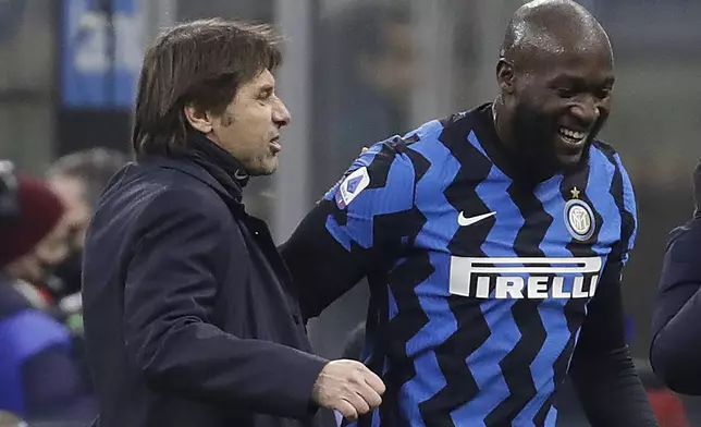 FILE - Inter Milan's head coach Antonio Conte congratulates his player Romelu Lukaku who scores the two goals during a Serie A soccer match between Inter Milan and Lazio at the San Siro stadium in Milan, Italy, Sunday, Feb. 14, 2021. (AP Photo/Luca Bruno, File)