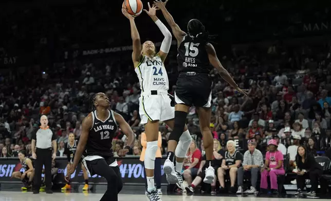 Minnesota Lynx forward Napheesa Collier (24) shoots against Las Vegas Aces guard Tiffany Hayes (15) during the second half of a WNBA basketball game Wednesday, Aug. 21, 2024, in Las Vegas. (AP Photo/John Locher)