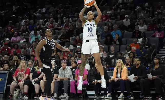 Minnesota Lynx guard Courtney Williams (10) shoots over Las Vegas Aces guard Chelsea Gray (12) during the second half of a WNBA basketball game Wednesday, Aug. 21, 2024, in Las Vegas. (AP Photo/John Locher)