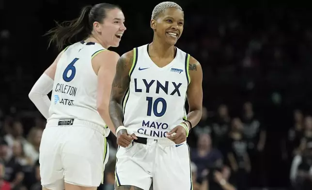 Minnesota Lynx guard Courtney Williams (10) celebrates after scoring against the Las Vegas Aces during the second half of a WNBA basketball game Wednesday, Aug. 21, 2024, in Las Vegas. (AP Photo/John Locher)